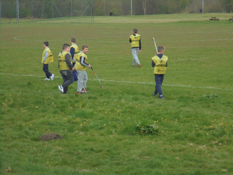Young boys cleaning the playing grass field